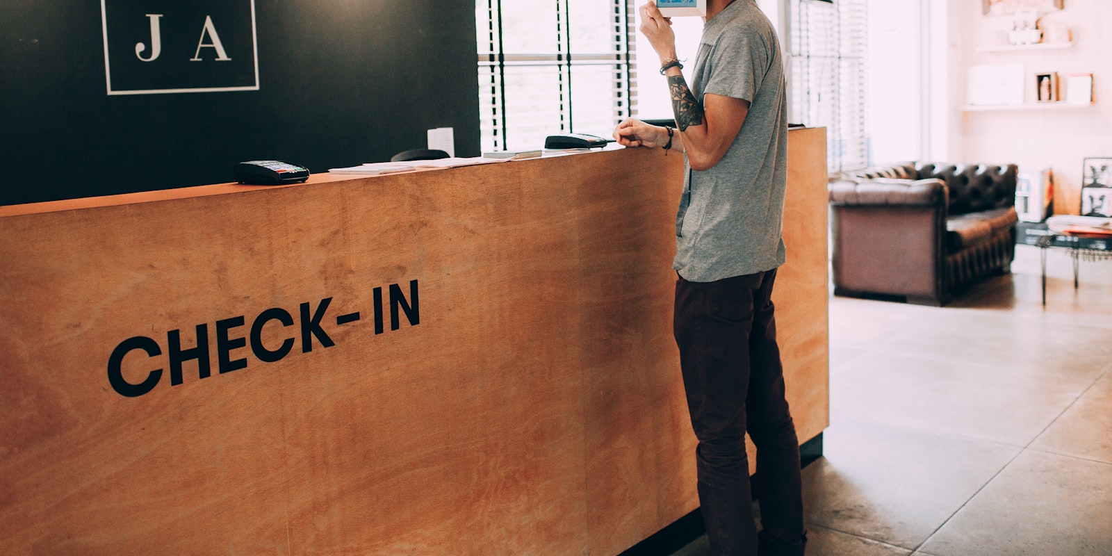 A traveller checking a hotel booking confirmation on a laptop before a visa application