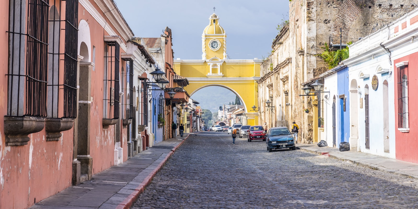A colonial street in Antigua Guatemala with Volcán de Agua rising in the background