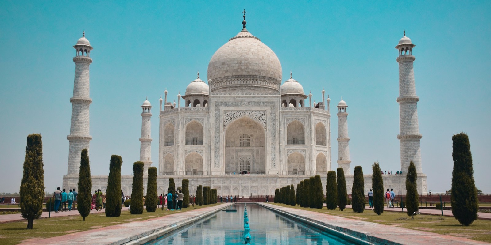 The Taj Mahal reflected in its still pool at Agra, India