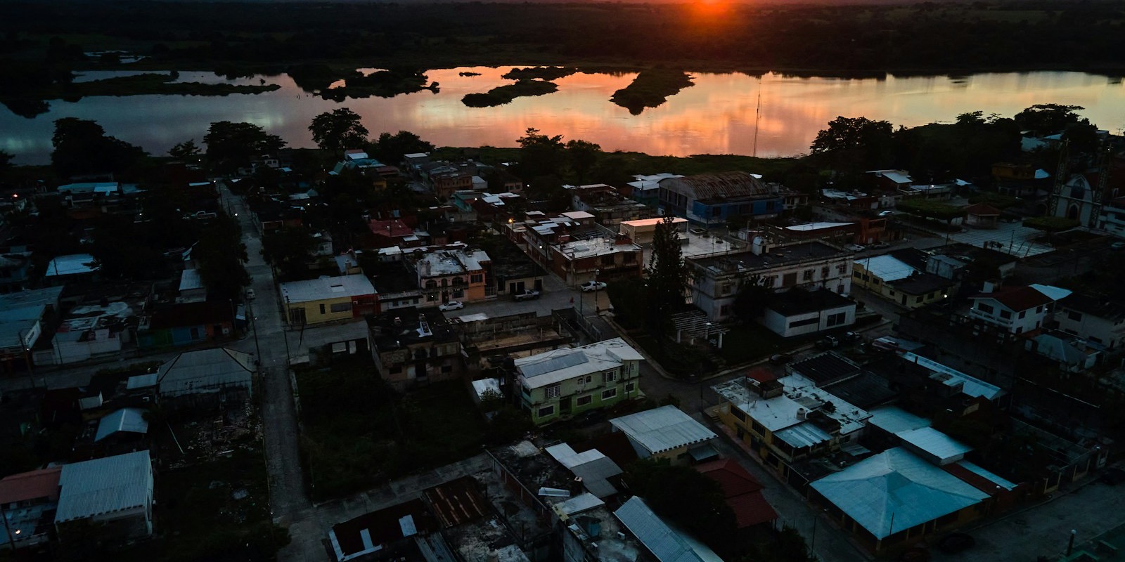 Sunset over a Mexican beach town with a small airport runway visible in the distance