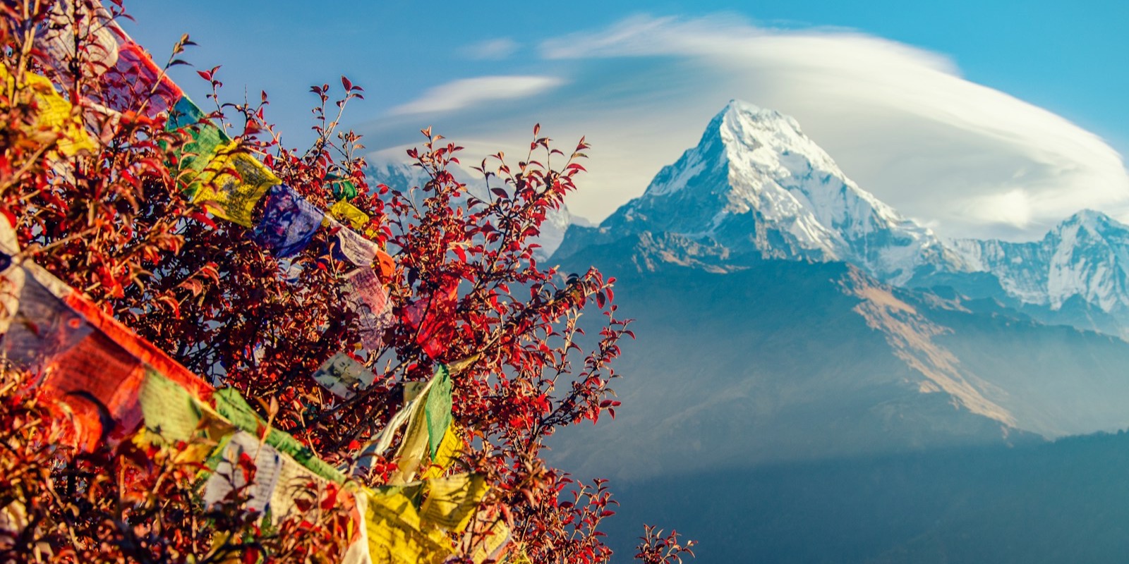A snow-covered Himalayan peak under a clear sky in Nepal